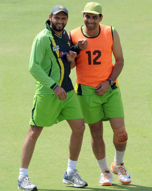 Shahid Afridi and Misbah-ul-Haq share a light moment during practice, Mohali, March 27, 2011