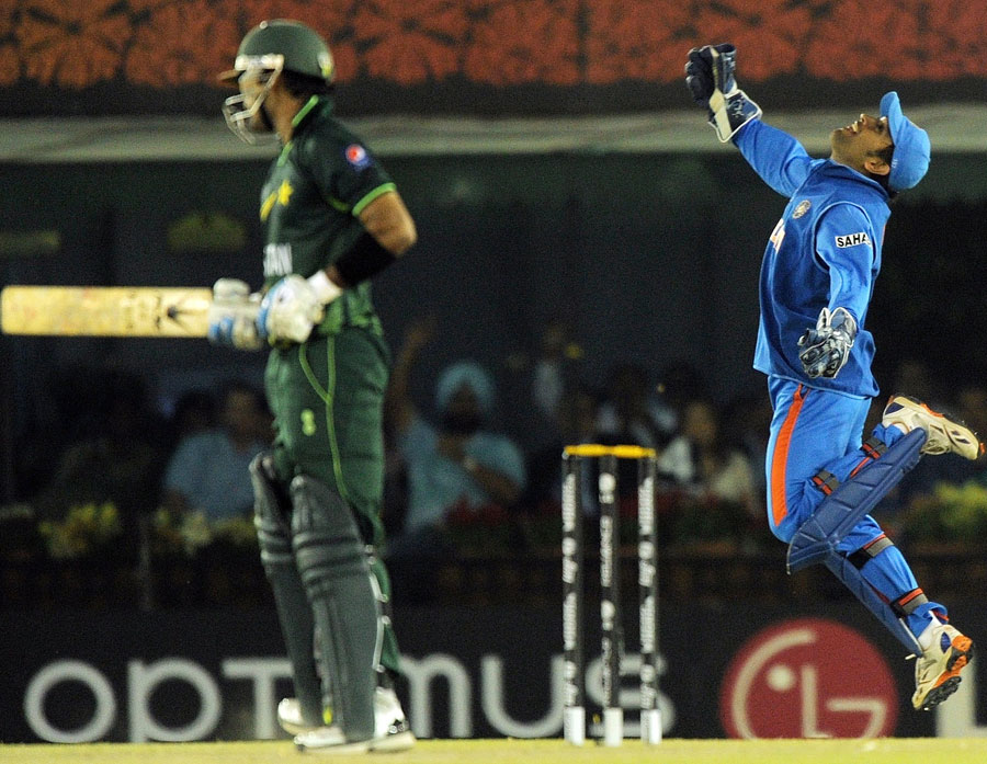 MS Dhoni celebrates after taking the catch that dismissed Mohammad Hafeez