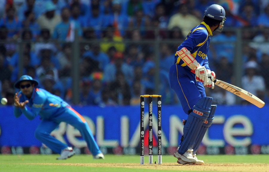 Upul Tharanga watches as Virender Sehwag swoops to catch him in the slips