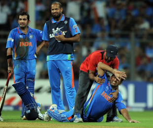 MS Dhoni is attended to after feeling some pain in his side, India v Sri Lanka, final, World Cup 2011, Mumbai, April 2, 2011