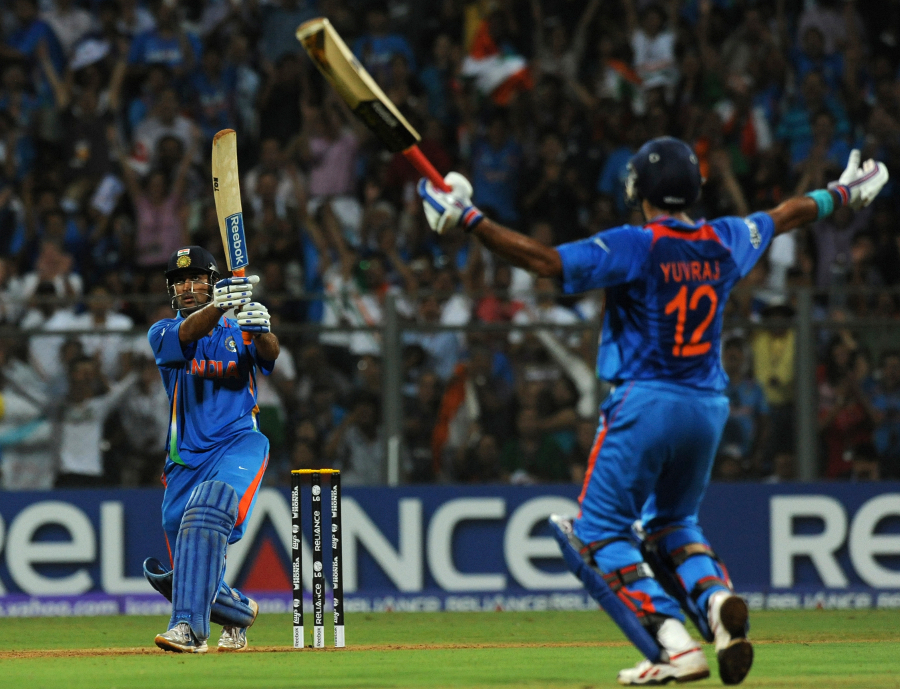 MS Dhoni watches the winning six sail over the boundary as Yuvraj Singh raises his arms in triumph