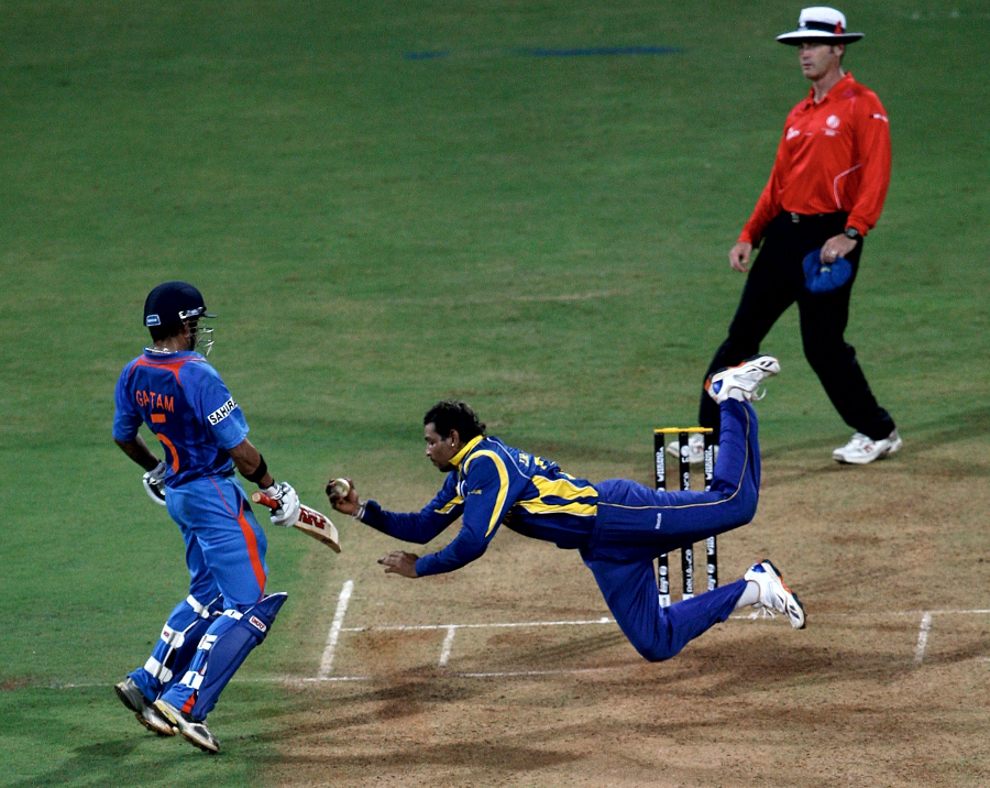 Tillakaratne Dilshan leaps to his right to dismiss Virat Kohli caught-and-bowled