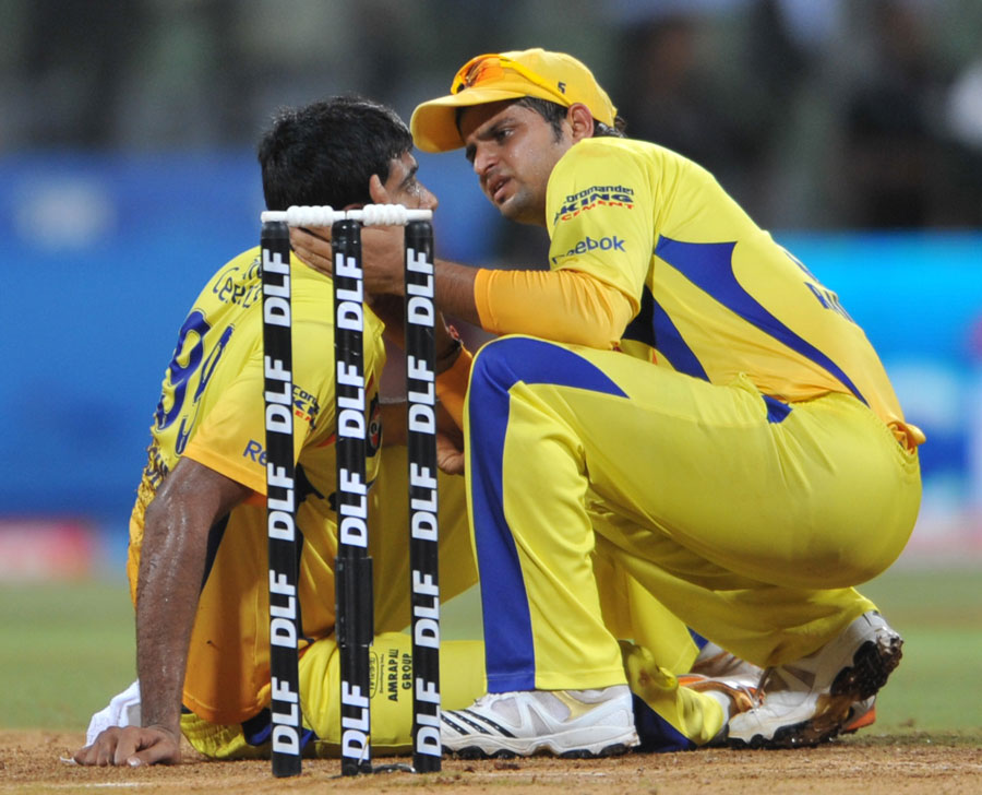 A concerned Suresh Raina checks R Ashwin after he took a blow to his head