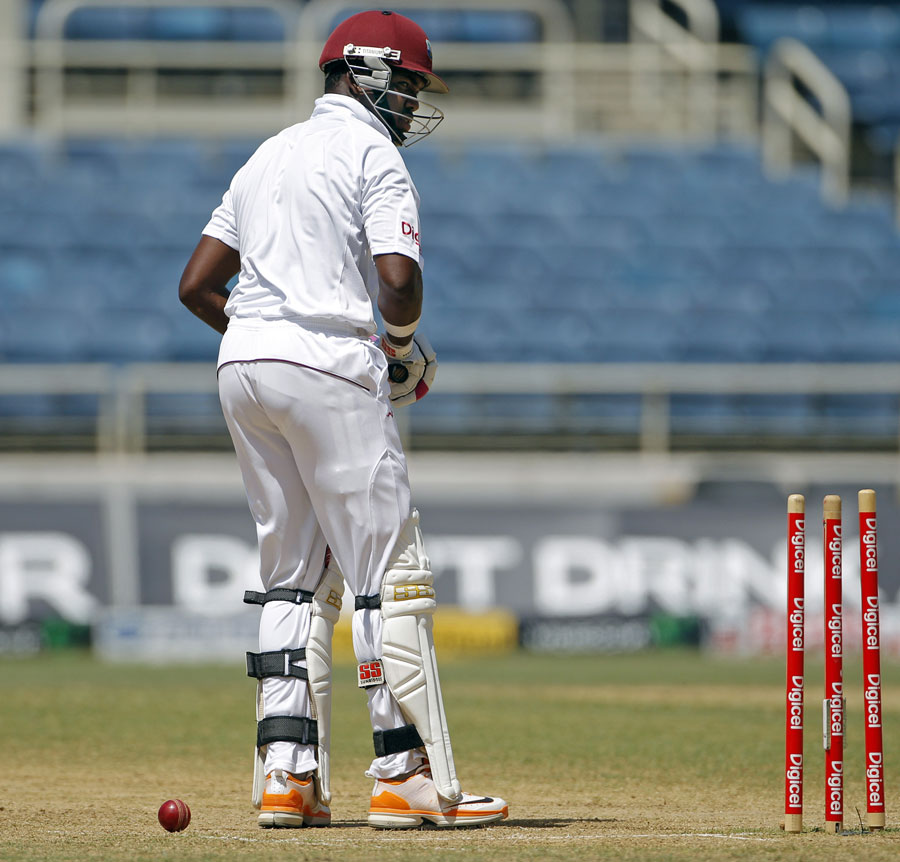 Darren Bravo looks back after being bowled round his legs 