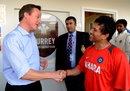 David Cameron, Britain's prime minister, speaks to Sachin Tendulkar
