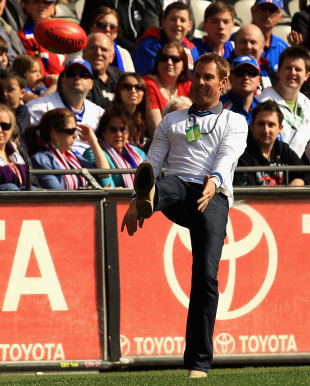 Shane Warne entertains the crowd at an Australian Football League match, Melbourne, September 3, 2011