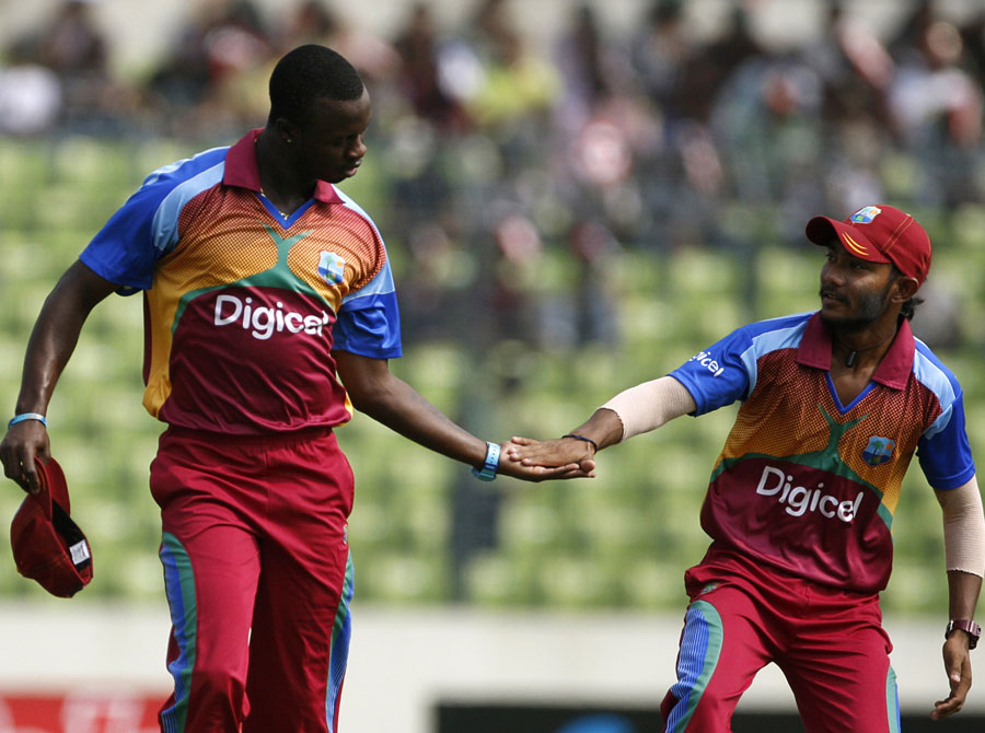 Kemar Roach and Devendra Bishoo get together after a wicket