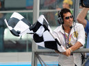 Sachin Tendulkar waves the chequered flag at the inaugural Indian Grand Prix