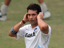 Sachin Tendulkar gestures by covering his ears during practice in Delhi
