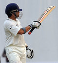 Sachin Tendulkar acknowledges applause after reaching 15,000 Test runs