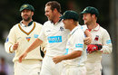 Jon Holland and his team-mates celebrate the wicket of VVS Laxman
