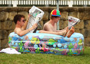 Fans relax in a blow-up swimming pool