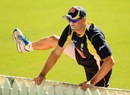 Michael Hussey does some stretches at training