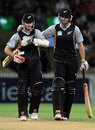 Kane Williamson and Andrew Ellis walk off after a successful chase