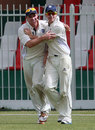 Ryan Flannigan celebrates with a team-mate after taking a catch