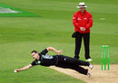 Nathan McCullum stretches to field off his own bowling