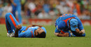 Irfan Pathan and Suresh Raina after their collision