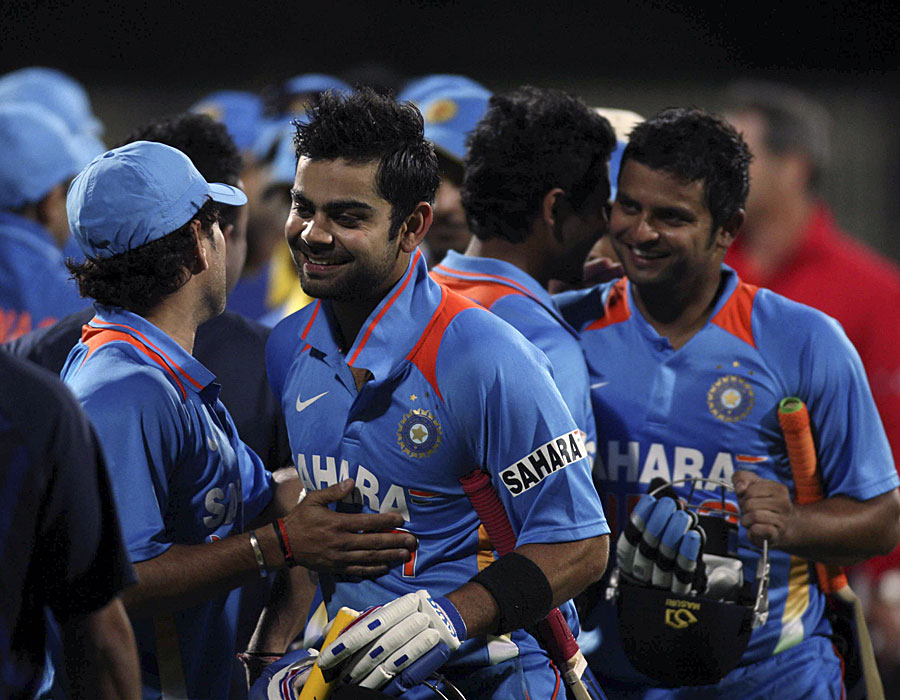 Virat Kohli is congratulated by team-mates after his blitz