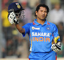 Sachin Tendulkar holds up his India helmet after reaching his century 