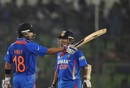 Virat Kohli raises his bat after reaching his half-century 