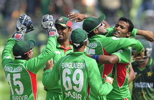 Bangladesh players crowd Nazmul Hossain after taking a wicket, Bangladesh v Pakistan, Asia Cup. final, Mirpur, March 22, 2012