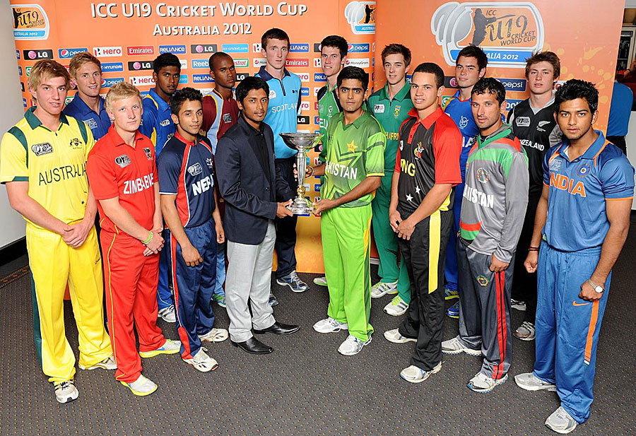The captains of the 16 Under-19 teams pose with the World Cup trophy