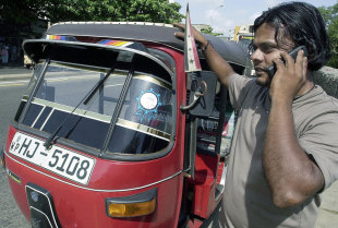 A tuk-tuk driver talks on the phone, Colombo, June 21, 2004