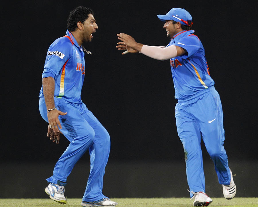 Yuvraj Singh and Suresh Raina celebrate AB de Villiers' wicket
