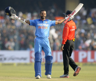 Shikhar Dhawan raises the bat after reaching his century, India v West Indies, 3rd ODI, Kanpur, November 27, 2013