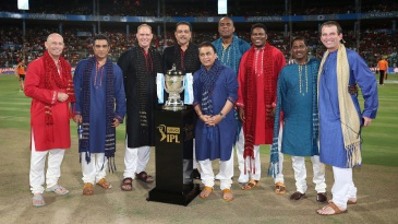The commentary team for the final poses with the IPL trophy