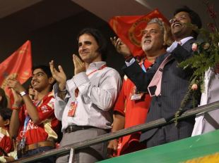 (From left) Dean Kino, head of the Champions League governing council, Bangalore Royal Challengers owner Vijay Mallya, and Lalit Modi, Chairman of the Champions League, applaud the action